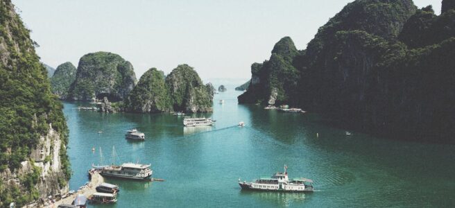 A breathtaking view of Halong Bay with boats navigating through limestone islands.